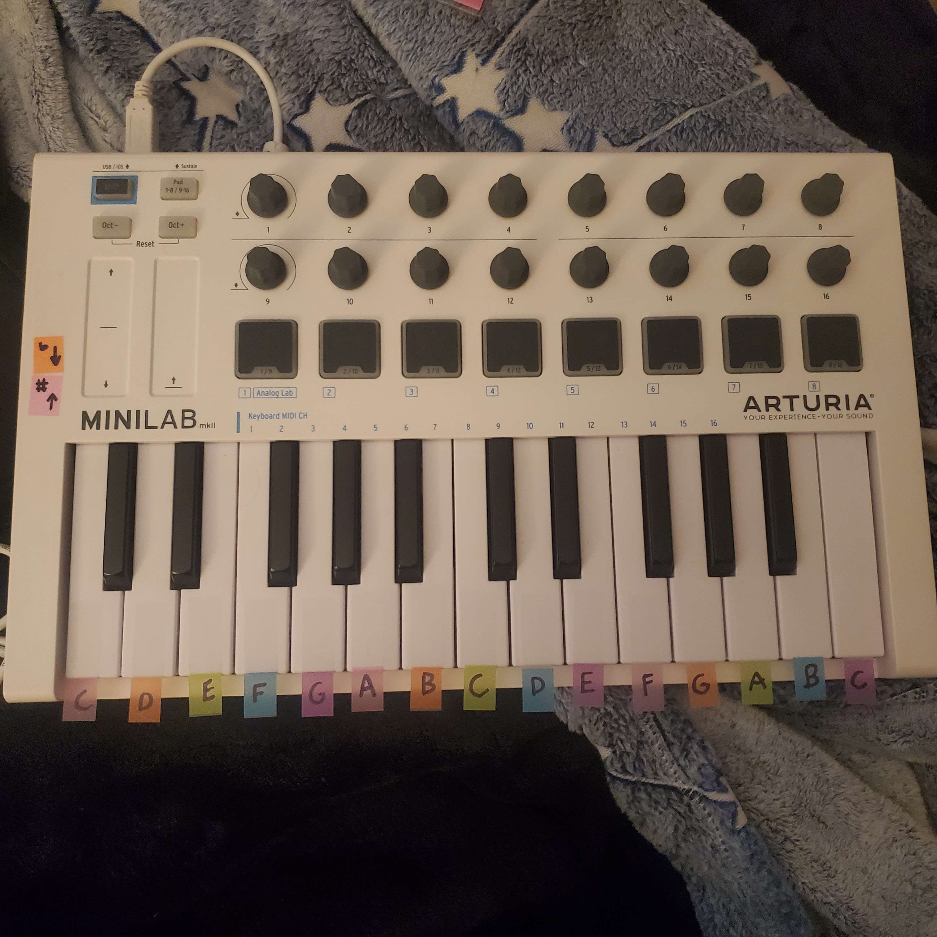 arturia minilab mark 2, with colored sticky note tabs on the keys