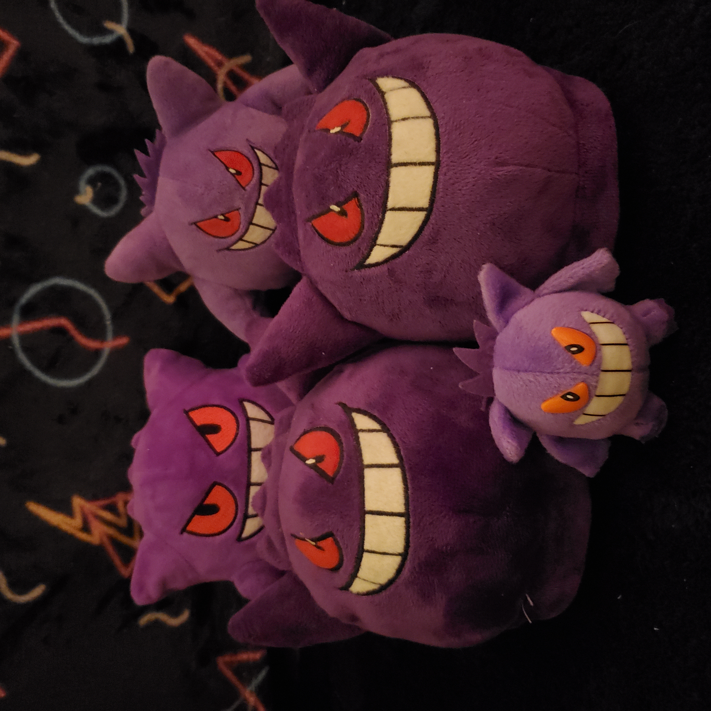 three gengar plush and a pair of gengar slippers