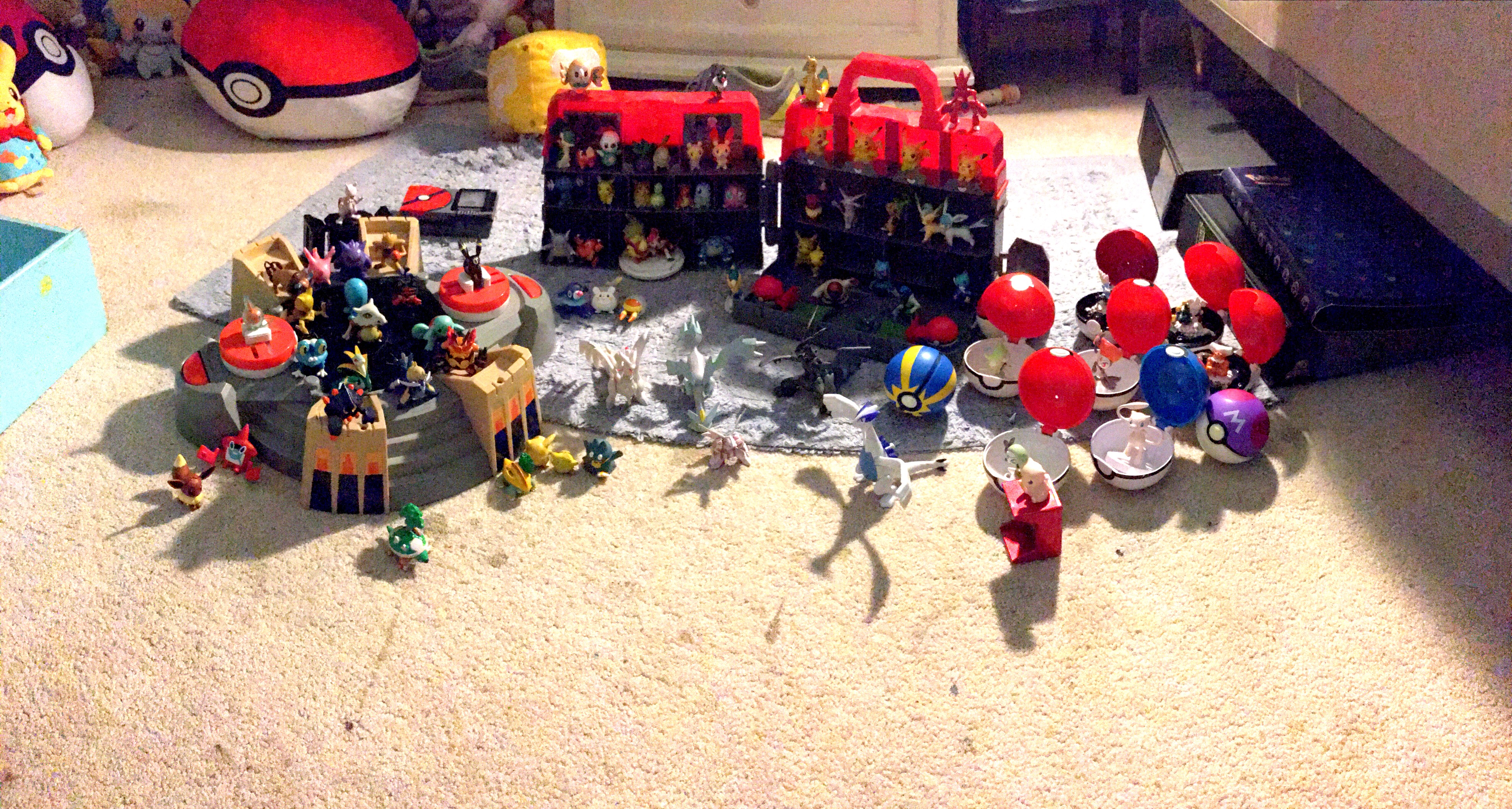 numerous TOMY figures on a pokemon center and a battlefield playset