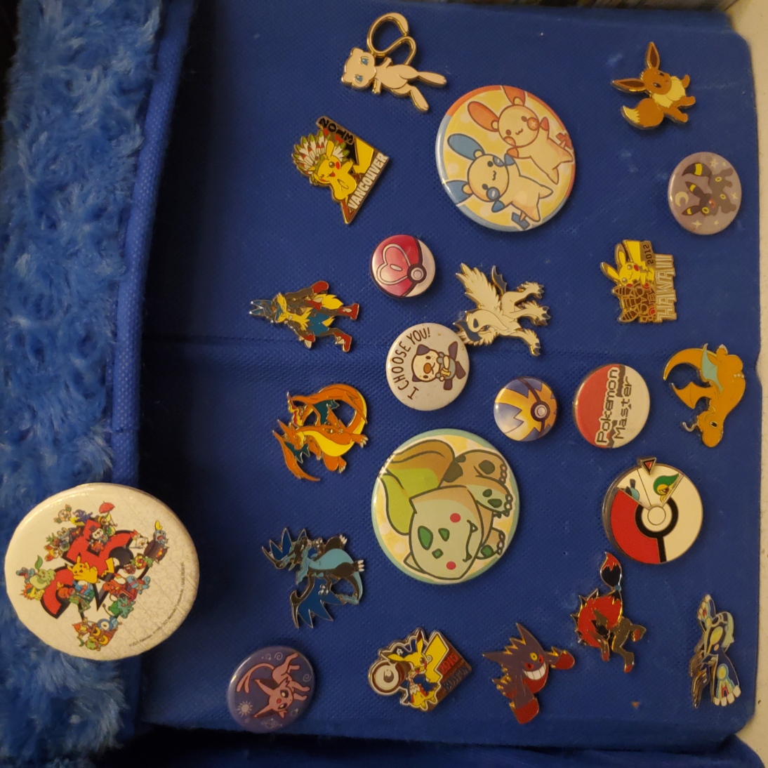 blue cube with numerous pokemon pins on it