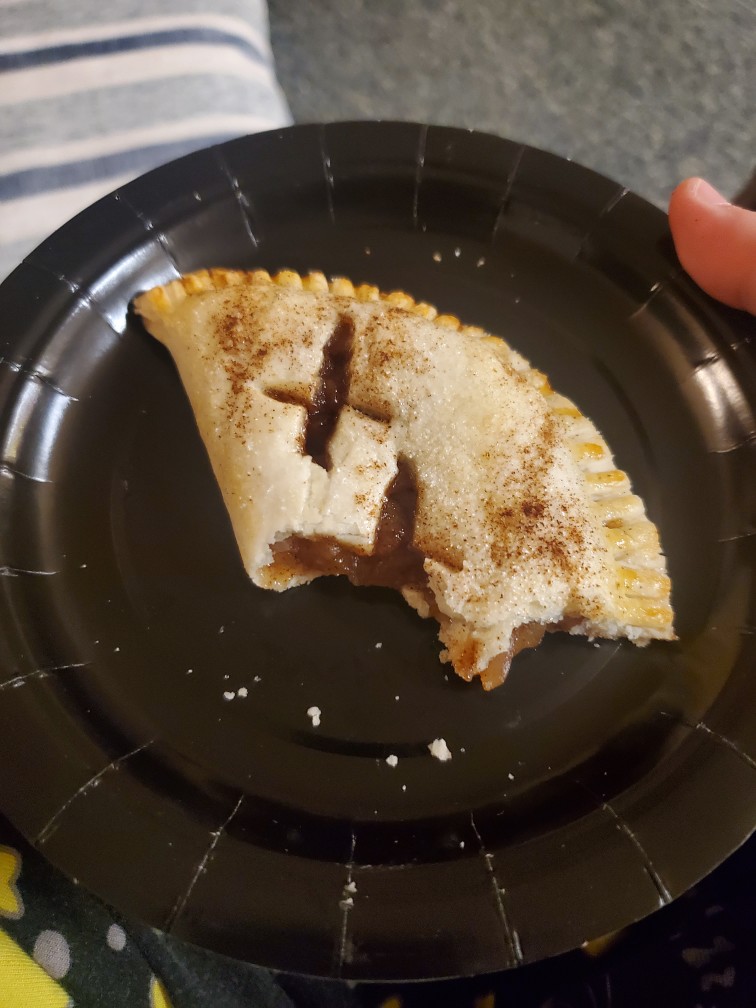 small apple hand pie with a bite taken out of it