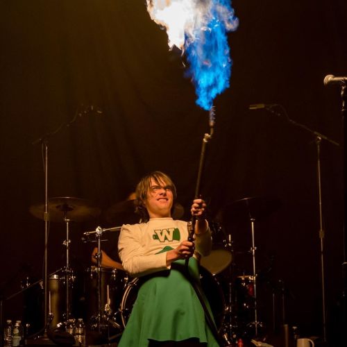 gerard way in a cheerleader dress with a flamethrower